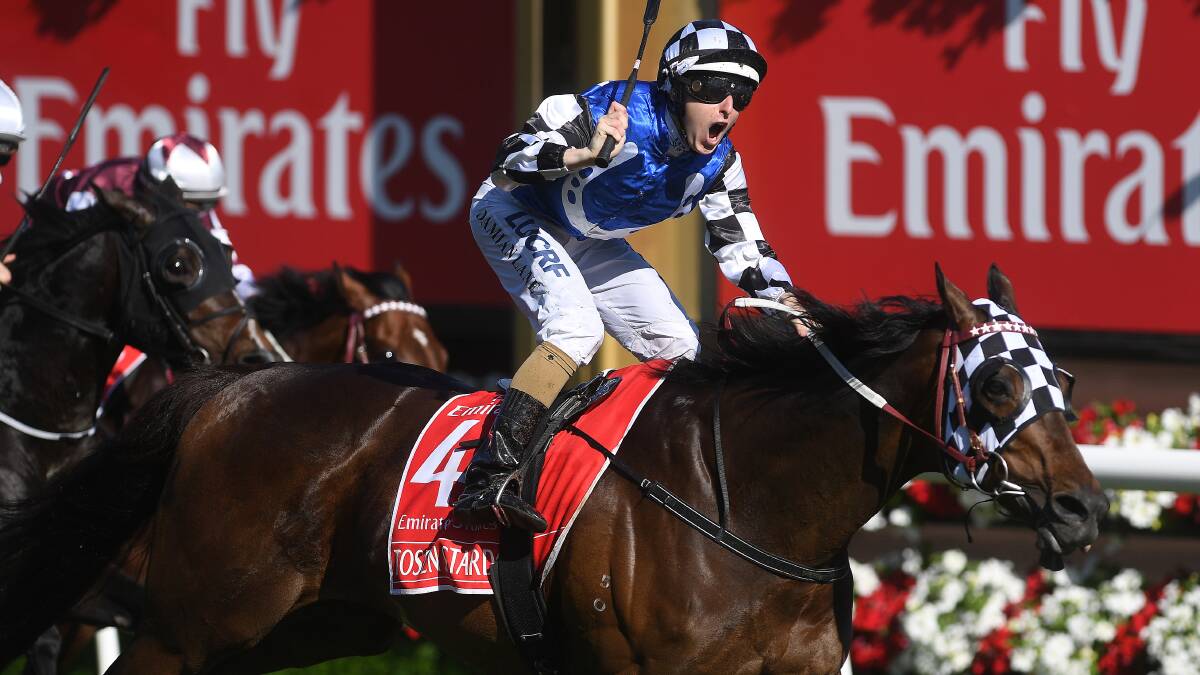 Damian Lane gives the victory salute on Tosen Stardom in Emirates Stakes at Flemington. Picture: AAP Images