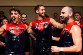 Bungaree recruits Mitch Comben, Dallas Martin, and Corey Edwards get a drenching during the Demons' song after downing Hepburn at Bungaree. Picture by Adam Trafford.