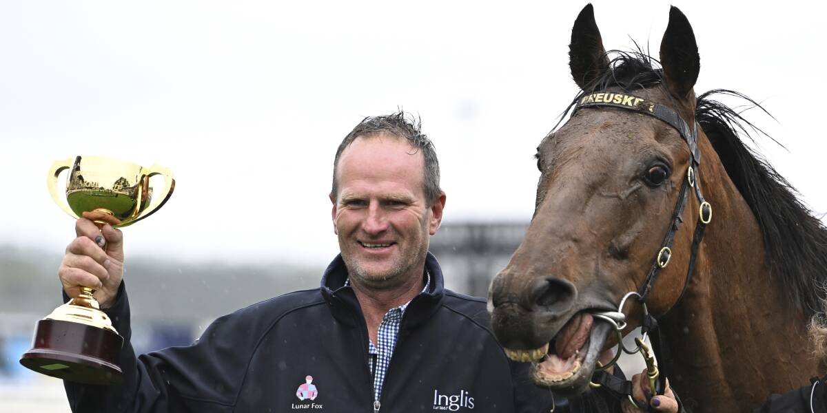 Triumphant Horsham trainer Paul Preusker with Captain Envious and the 2023 Sportsbet Ballarat Cup. Picture by Lachlan Bence.