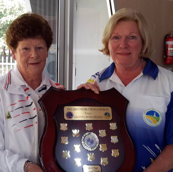 HANDOVER: Valerie Page presents the shield named in her honour to Geelong’s Maureen Reynolds.