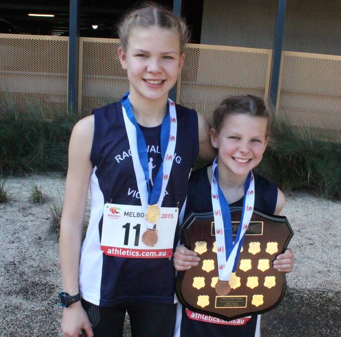 CHAMPIONS: Ballarat Race Walking Club sisters Jemma and Alanna Peart with the national road team gold medals and individual bronze medals. Alanna is also holding the team shield.