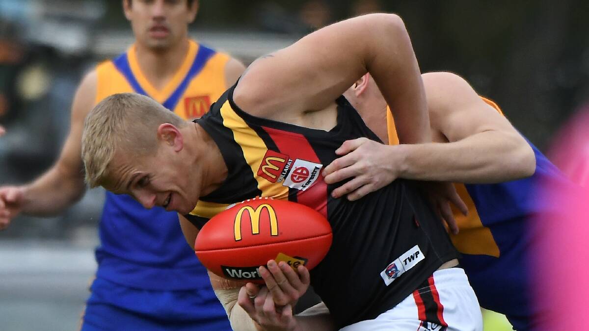 Bacchus Marsh ruckman Daniel Burton is pinned in a tackle against Sebastopol on Saturday. Picture: Lachlan Bence