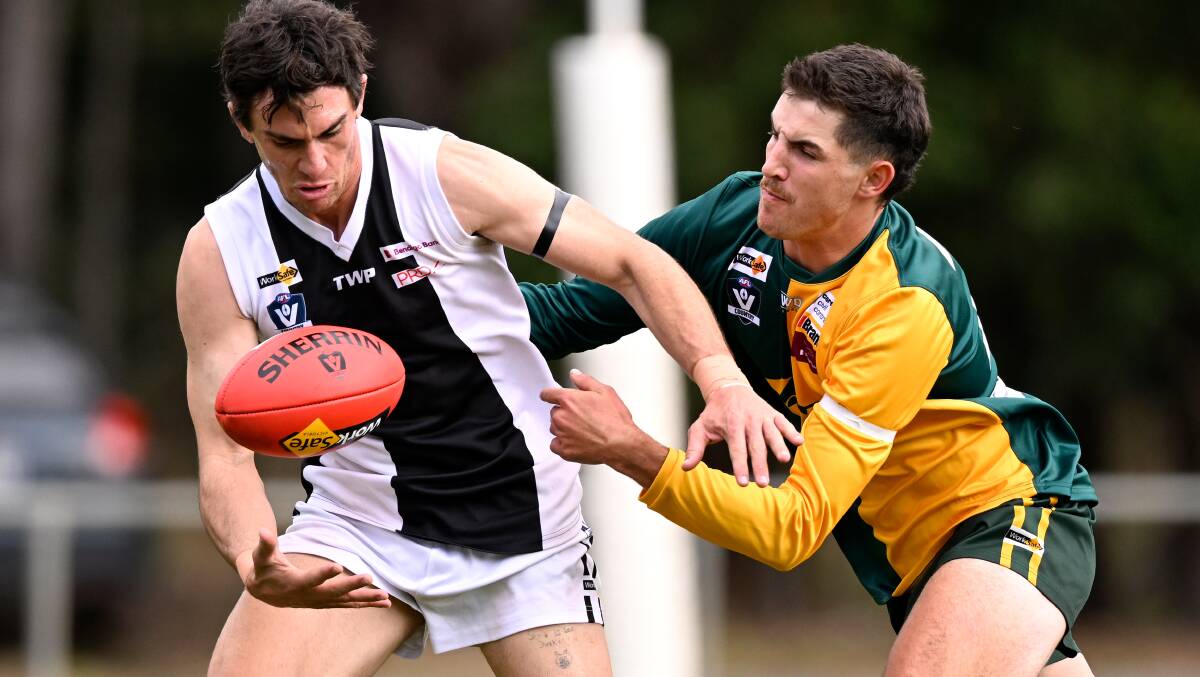 Anthony Caligiuri (Dunnstown) tries to shrug off Gordon ruckman Macauley Griffiths at Gordon on Saturday. Picture by Adam Trafford