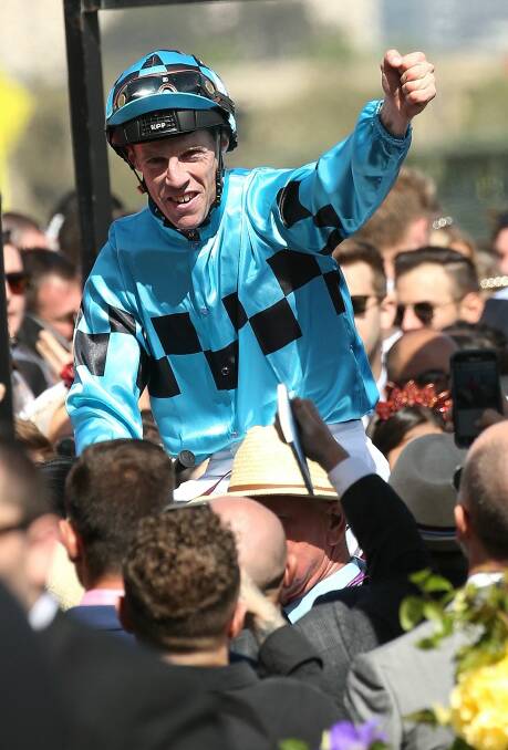 VICTORY SALUTE: John Allen punches the air on returning to scale on Victoria Derby winner Extra Brut. Picture: AAP Images