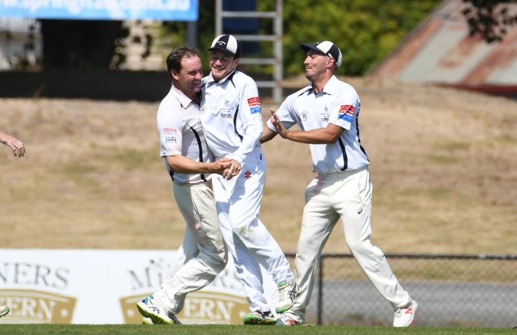 BIG MOMENT. Darren Fletcher, Brendan Moyle and Jarrod Burns celebrate a Mt Clear wicket at the Eastern Oval. Picture: Kate Healy