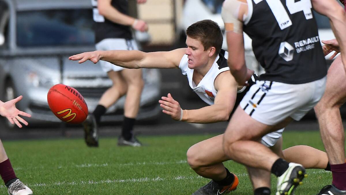 Fletcher Loader (North Ballarat City) dives for a possession against Redan. Picture: Lachlan Bence