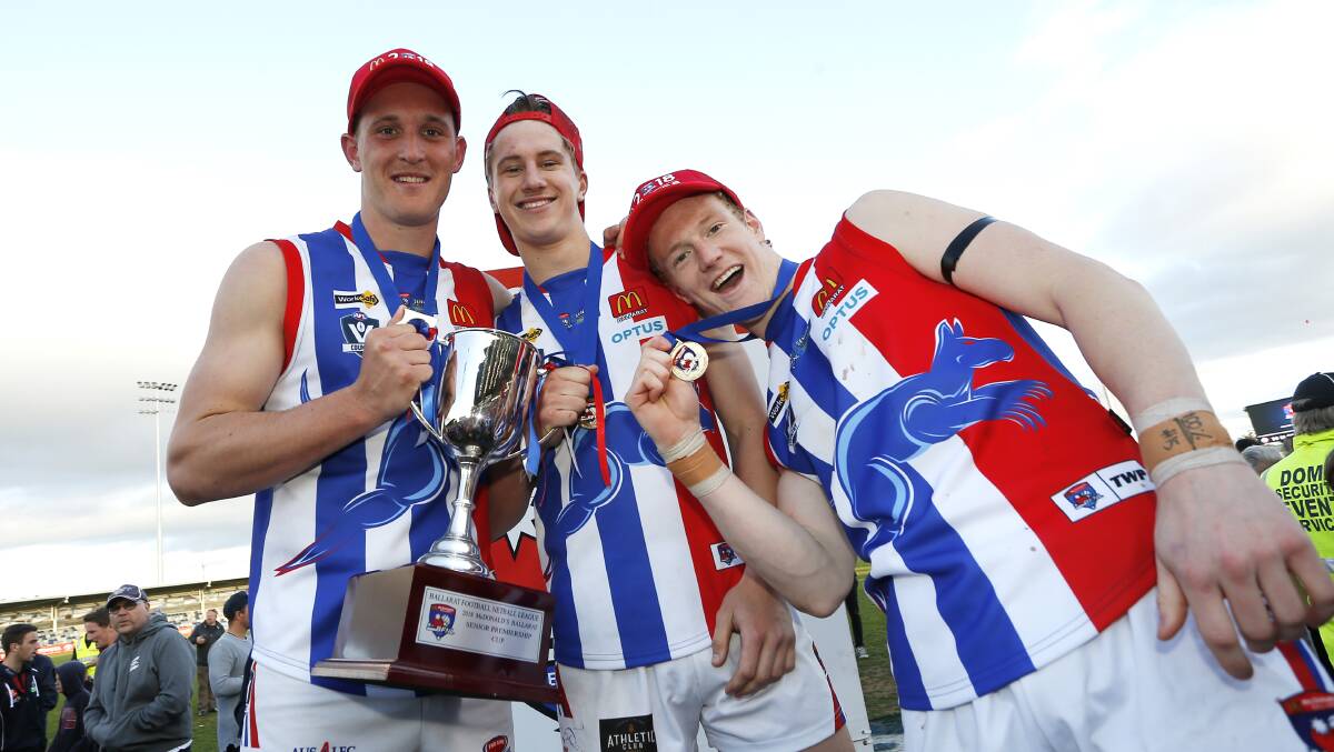 ALL SMILES:  Bryson McDougall, Jordan Johnston and Cam Lovig show off the spoils of the premiership.