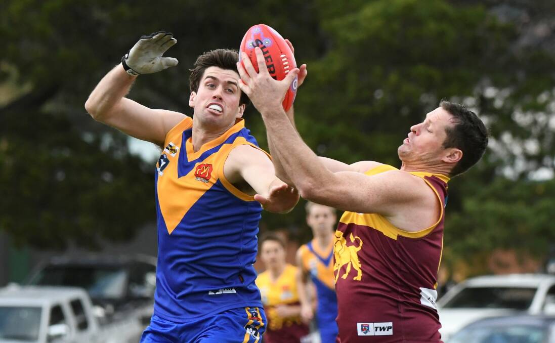 Tony Lockyer (Sebastopol) arrives a little too late to spoil Redan's Lachie George at Marty Busch Reserve. Pictures: Lachlan Bence