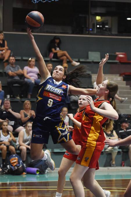 HIGH FLYING: Georgia Amoore (Rush) rises above Melbourne Tigers' Hannah Giddey in an attack on the basket at the Minerdome. Picture: Kate Healy