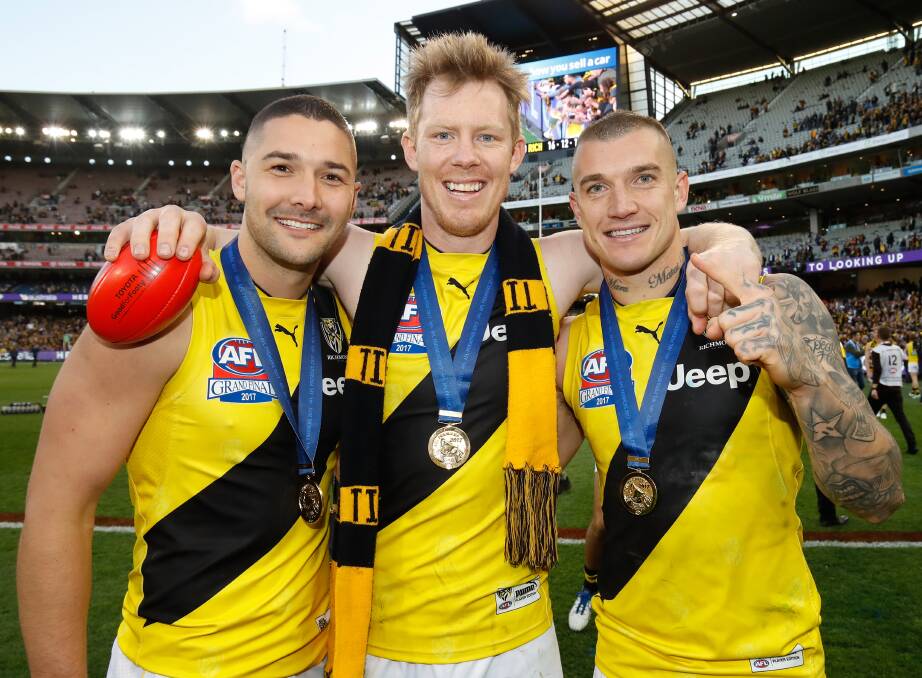RIVALS: Shaun Grigg, left, celebrates the 2017 premiership with Richmond teammates Jack Riewoldt and Dusty Martin. They'll be rivals on Saturday night.. Picture: /Adam Trafford/Getty Images
