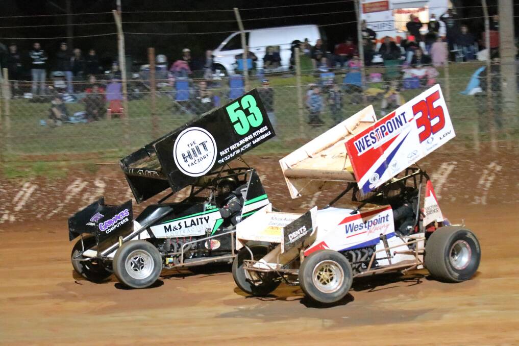 HEAD-TO-HEAD: Victorian sprintcar champion Mark Laity with his nose in front of Adam Greenwood. Picture: Random Panda Photography