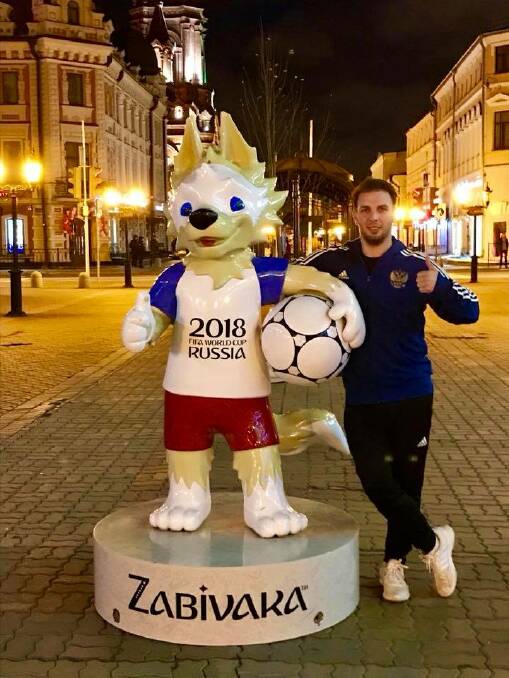 WORLD CUP FEVER: Corey Smith with the World Cup mascot, Zabivaka. The wolf's name means "the one who scores”.
 