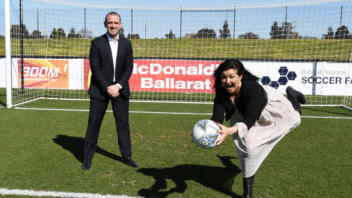 SAVE: Ballarat mayor Cr Sam McIntosh tests her goalkeeper skills with Ballarat City FC director of coaching James Robinson at the "Festival of Football" launch.