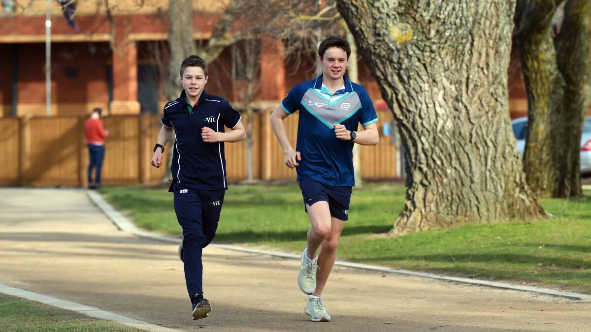 ON THEIR WAY: Ballarat triathletes Oscar Wootton, 14 and Darcy Williams, 17, stretch out around Lake Wendouree. Picture: Kate Healy