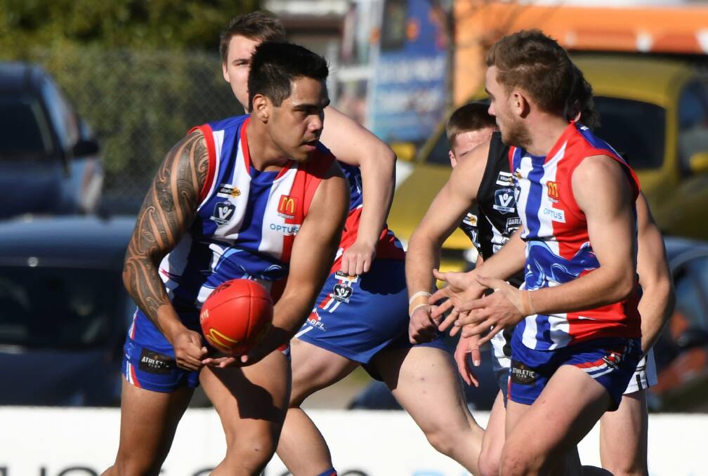 Mickitja Rotumah-Onus feed a handball out to East Point teammate Lucas Dahlenburg at the Eastern Oval. Picture: Lachlan Bence
