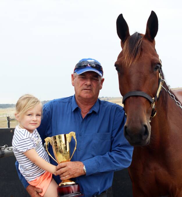 BIG NIGHT: Warren Stewart and his granddaughter Willow Tonkin and their mare Delight Me and the Ballarat Pacing Cup trophy. Picture: Bianca Brehaut