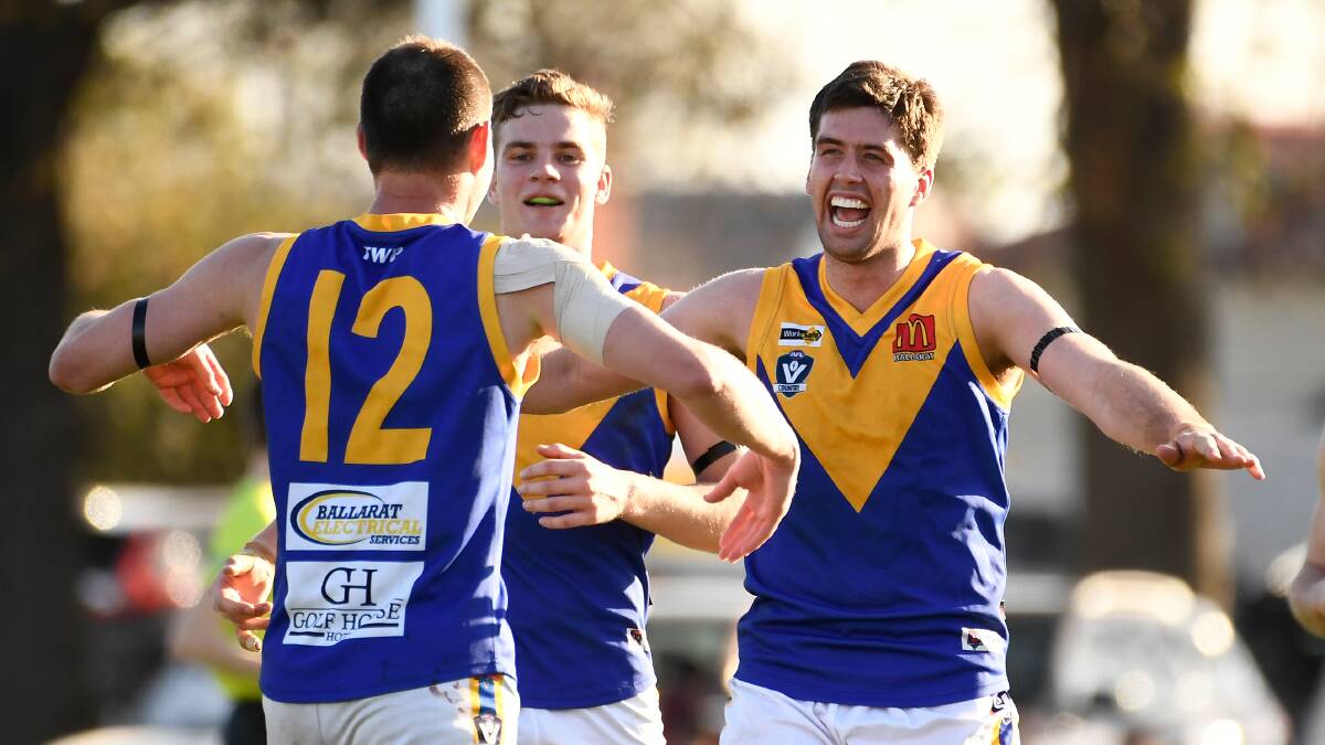 Tony Lockyer, right, Ben Hutt and and Lachie Cassidy begin the Sebastopol celebrations. Lockyer and Cassidy were VFL teammates at North Ballarat and joined the Burra last season after the Roosters folded. Picture: Adam Trafford.