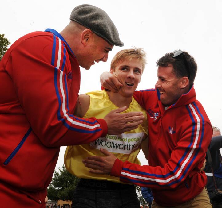 SWAMPED: Isaac Dunmall is congratulated by past Stawell Gift winners Luke Versace and Andrew Robinson, who he described as inspirations. Picture: Paul Carracher
