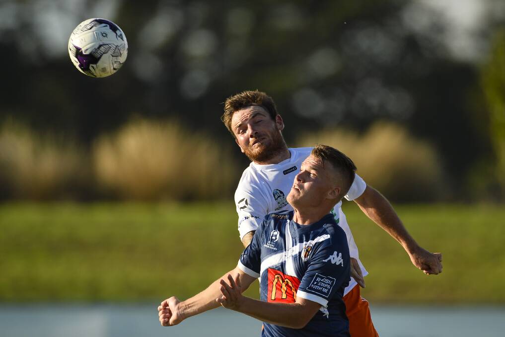 CLOSE ATTENTION: Ballarat City FC's Michael Trigger uses his strength to get between a Goulburn Valley Suns defender and the ball in this aerial battle. Pictures: Dylan Burns