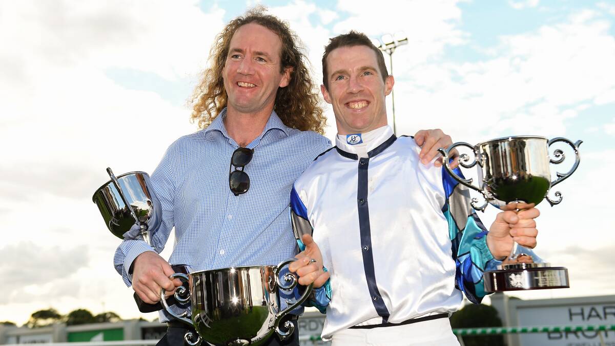 Ciaron Maher and John Allen with the Doomben Cup. Picture: AAP Images