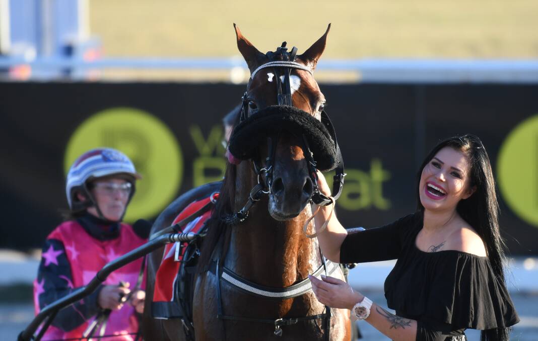 SHEER JOY: A delighted stablehand Nora Viljanen with Victoria Derby heat winner Hurricane Harley (Amanda Turnbull). Picture: Lachlan Bence
