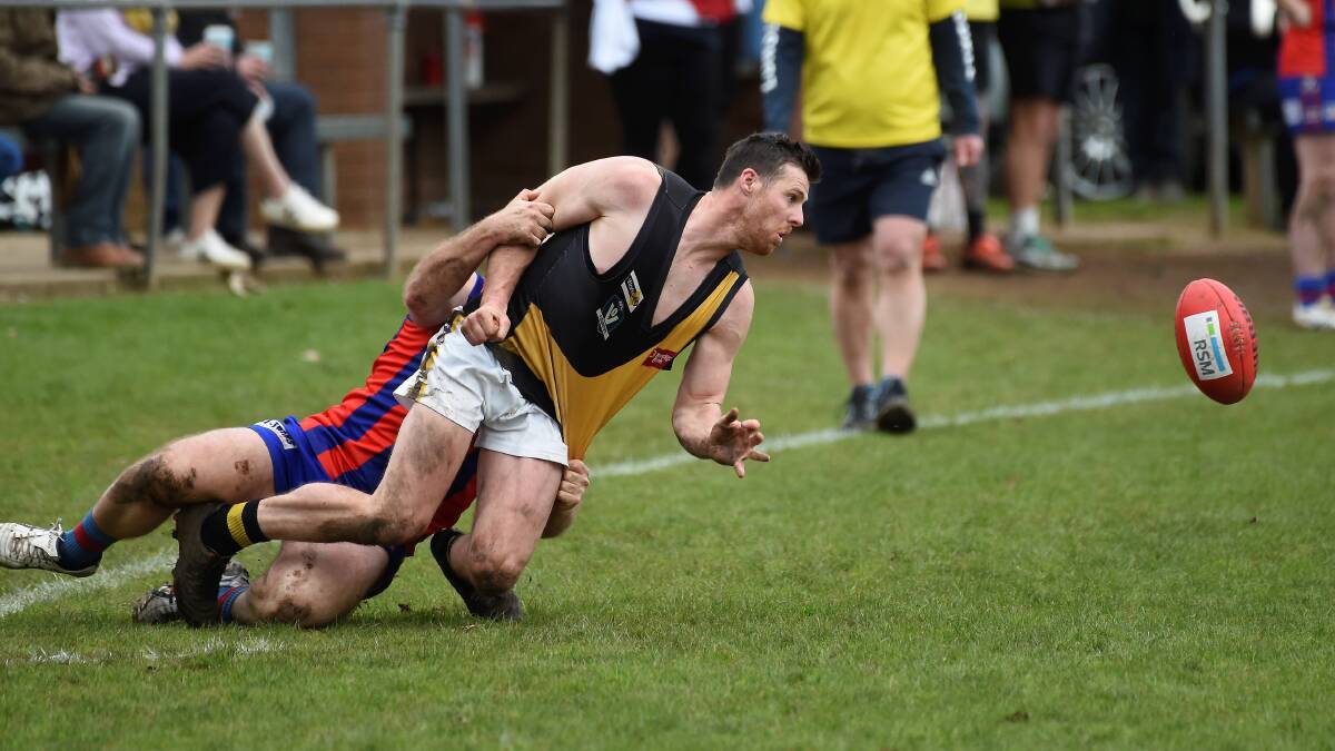 Springbank's Joel Maher is dragged back in a tackle. Picture by Lachlan Bence.