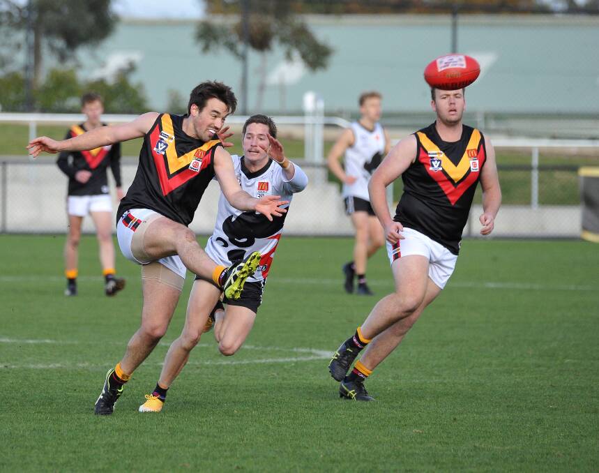 Bacchus Marsh defender Ryan Bartlett gets a kick away. Picture: Lachlan Bence