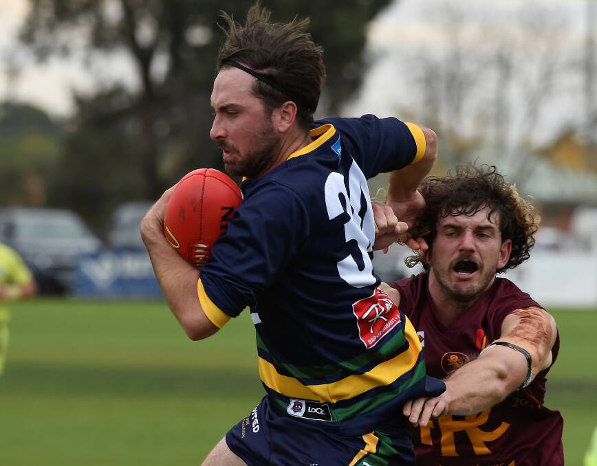 Lake Wendouree's Nathan Pring tries to evade Redan's Patrick Fitzgibbon during last year's Good Friday clash. Picture by Lachlan Bence.