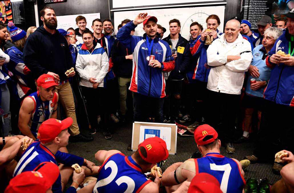 East Point coach Jake Bridges addresses his players and spectators after the 2019 BFNL grand final win. Picture: Adam Trafford