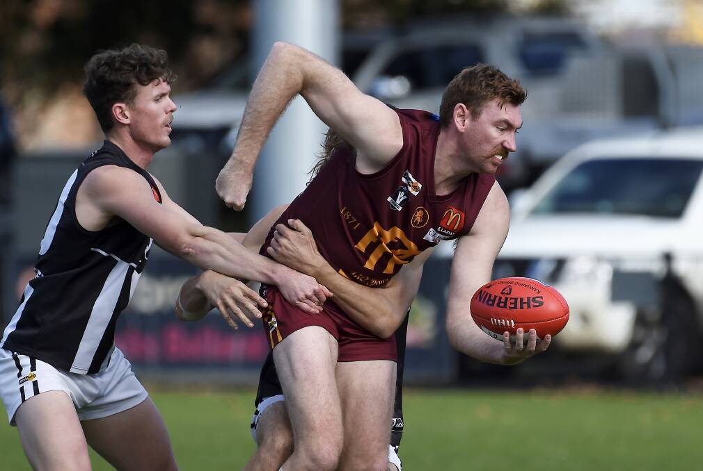 Nathan Dunstan looks to get the ball away. Picture: Lachlan Bence
