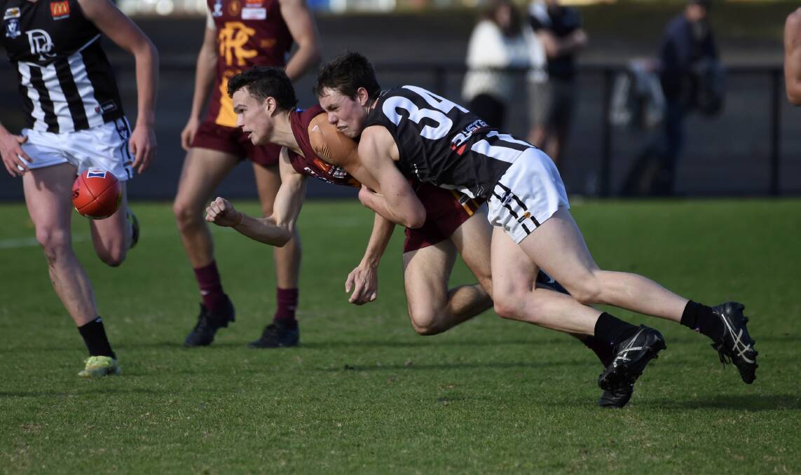 Darley's Cooper Murley nails Redan's Sam McDougall in a tackle. Picture: Lachlan Bence