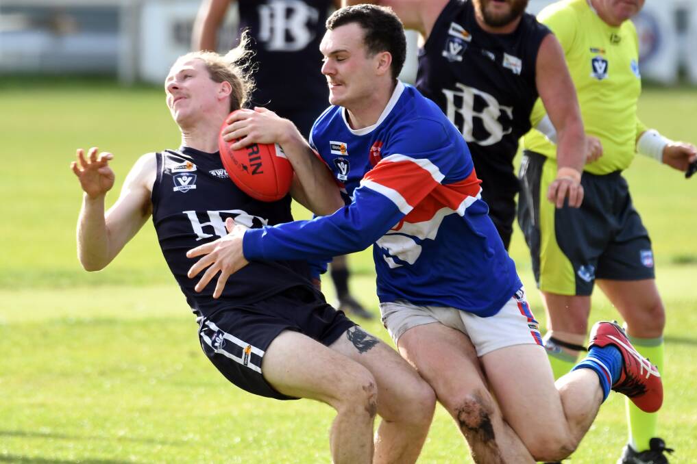 Ballan's Alistair Hine is brought down by Daylesford opponent Cameron Ralph. Picture: Kate Healy