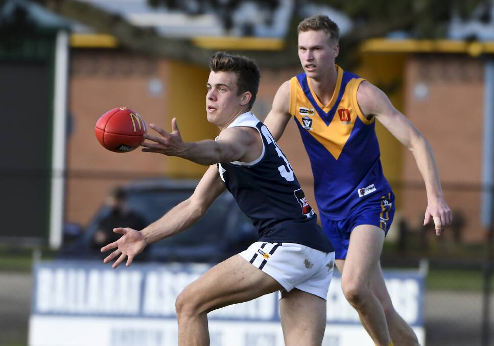 Melton South's Rhys Lees tries to drag the ball in against Sebastopol on the final day of the season. Picture: Lachlan Bence