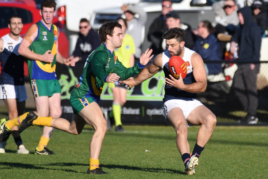 Mitchell Phillips closes in on Melton South forward Dylan Conway. Picture: Kate Healy