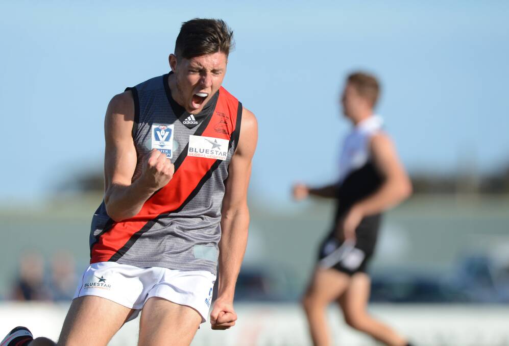 Nick O'Brien celebrates while playing for Essendon's VFL team.