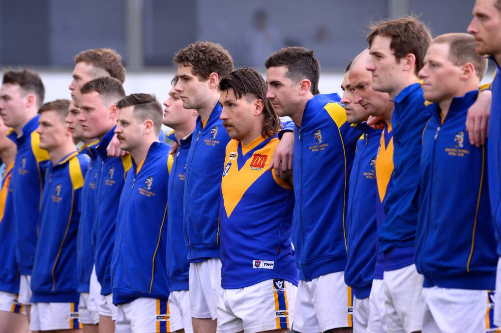 Sebastopol players line-up for the national anthem before the grand final. Picture by Adam Trafford.