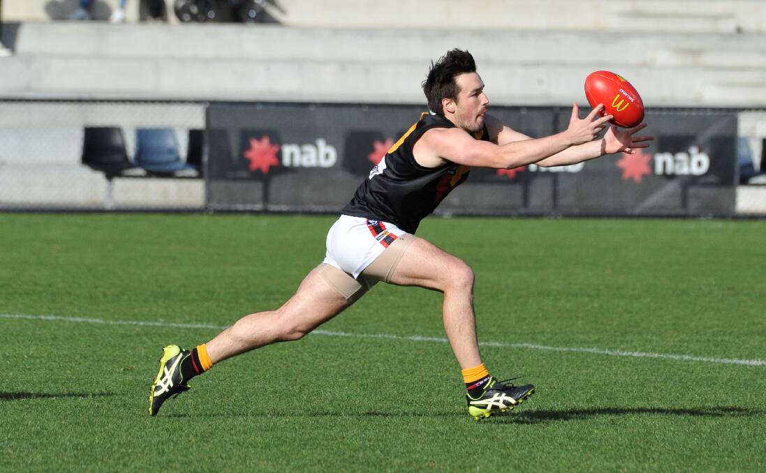 Bacchus Marsh assistant coach Ryan Bartlett tries to drag the ball in. Picture: Lachlan Bence