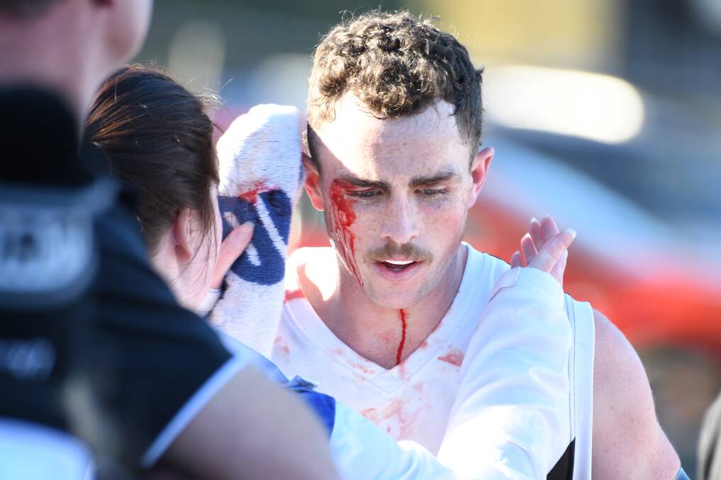  A bloodied Joseph Symons leaves the field during North Ballarat's round six win against East Point. Picture: Kate Healy