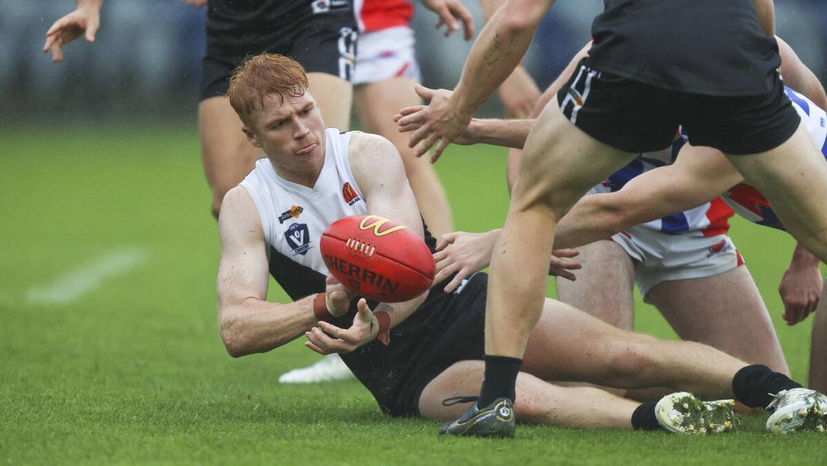 Jack Riding tries to get the ball out for North Ballarat. Picture: Luke Hemer