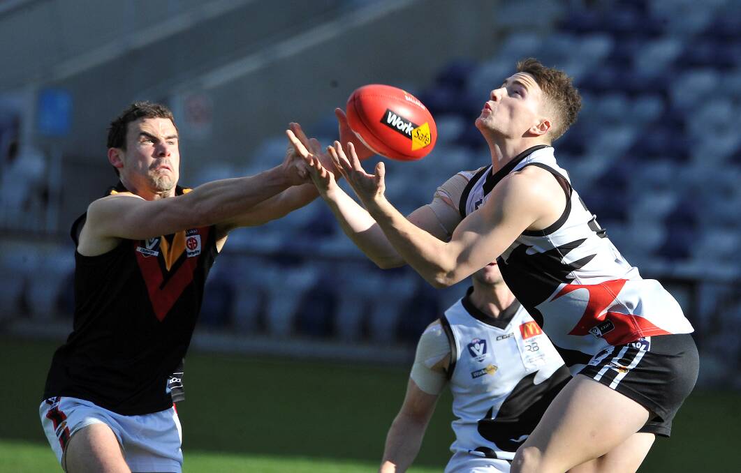 Tom German tries to spoil Brock Leonard's mark. Picture: Lachlan Bence