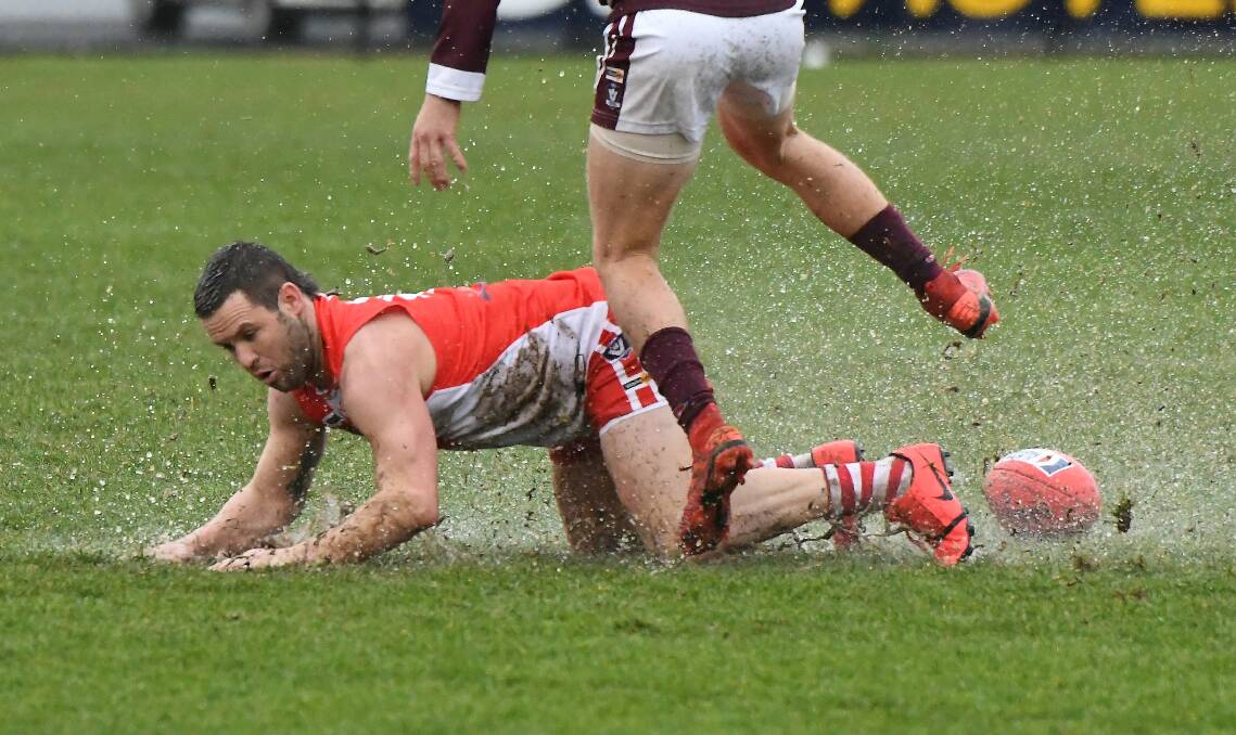 Andrew Hooper goes to ground on a wet day. Picture: Lachlan Bence