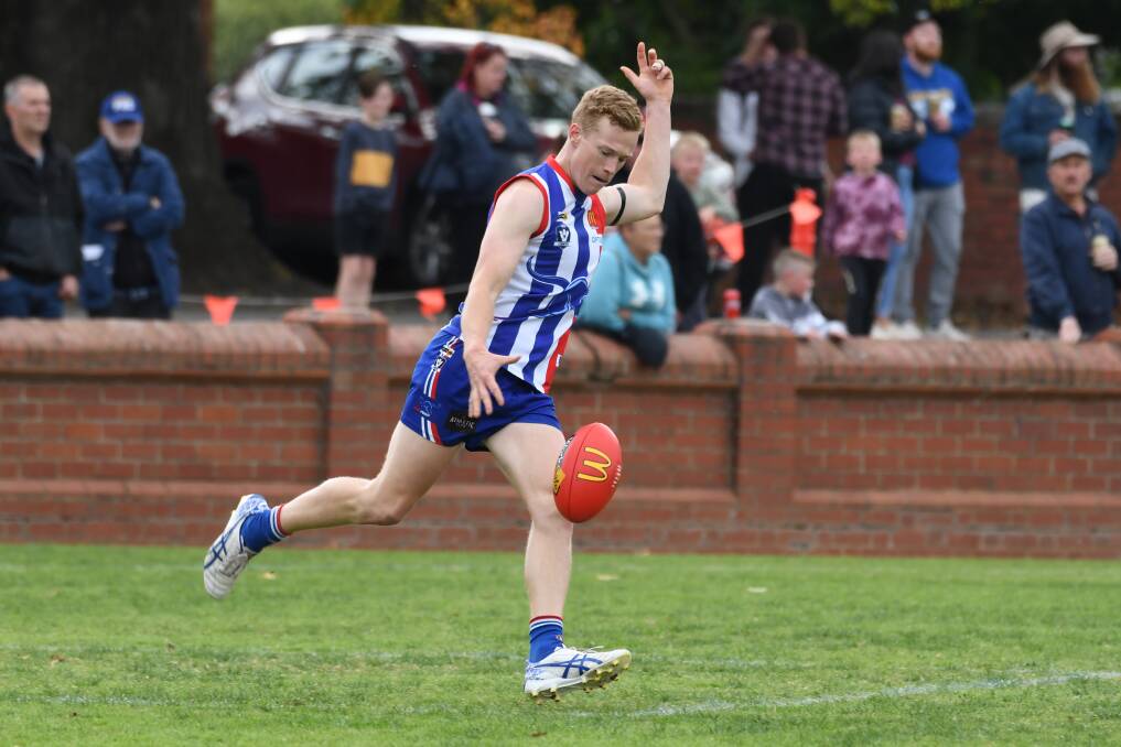Cameron Lovig gets a kick away in the Roos' season-opener. Picture: Kate Healy