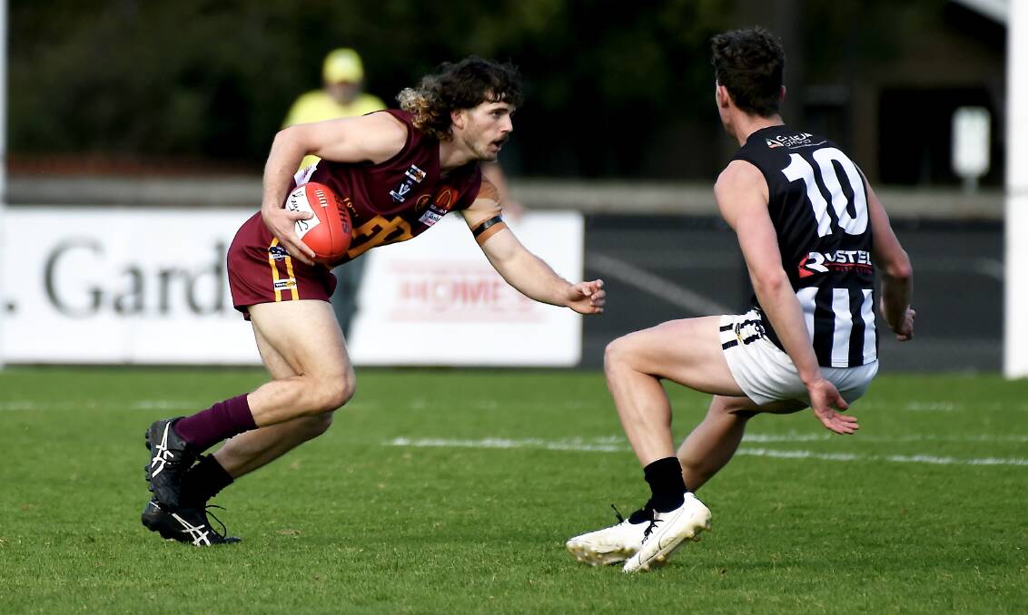 Redan's Patrick Fitzgibbon tries to beat Darley's Jack Bewley. Picture: Lachlan Bence