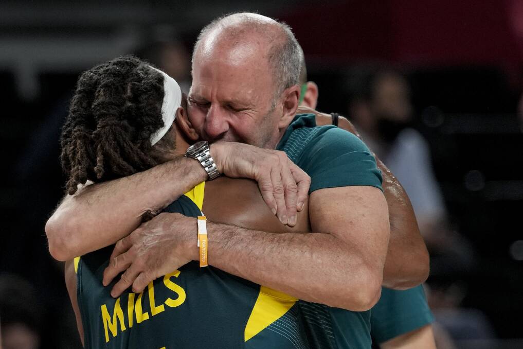 Brian Goorjian embraces Patty Mills, who dropped 42 points, after the Boomers won bronze. Picture: AP Photo/Eric Gay