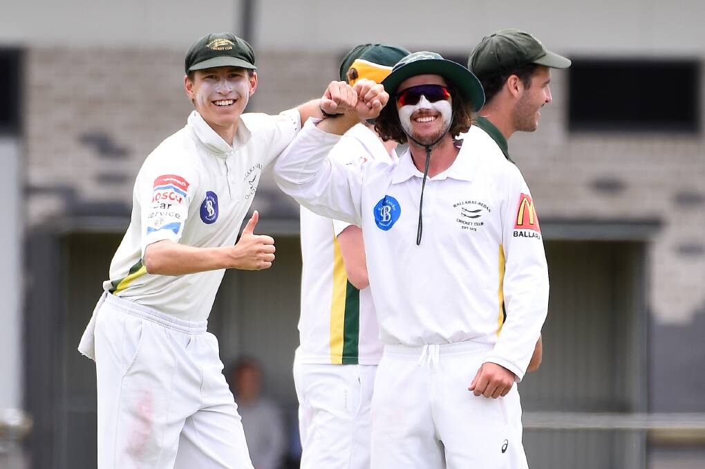 Ballarat-Redan players celebrate a wicket last season with a COVID-style handshake. Picture: Adam Trafford