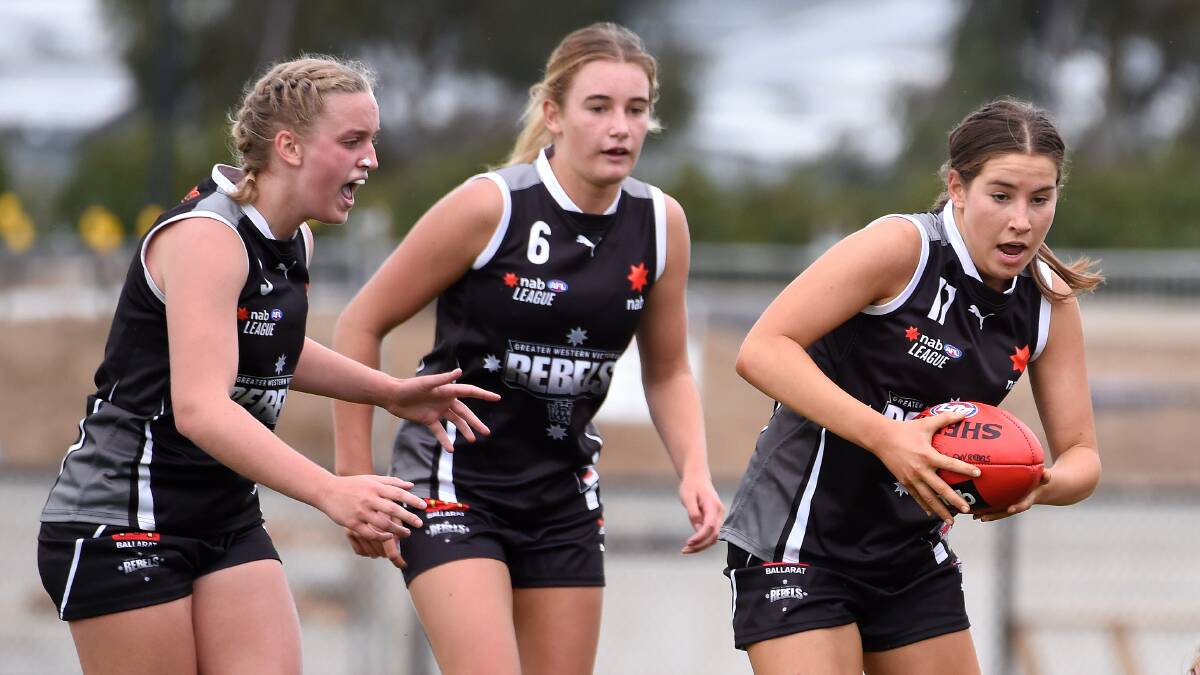 Ella Caris of the Rebels (right) in action ahead of Ally Trigg (left) and Stella Bridgewater last season. Picture: Adam Trafford