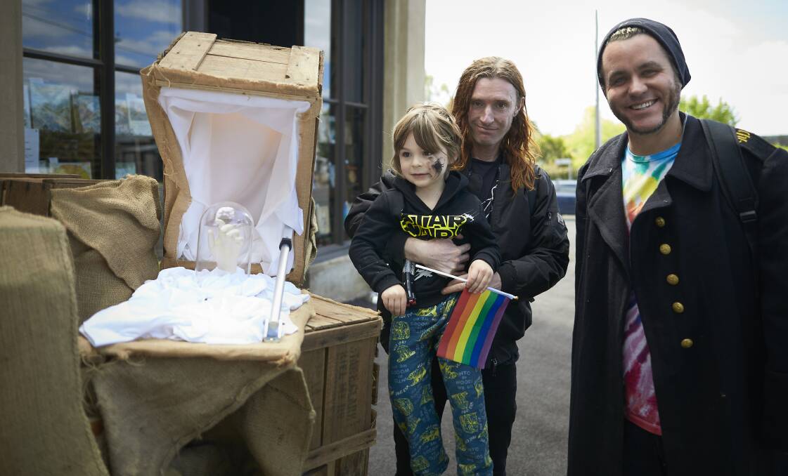 ROVING: Artists Dean Peterson and Jesse Stevens with Quincy, 4, and their creation Crate Expectations at the Linton on Literary Arts festival. Picture: Luka Kauzlaric