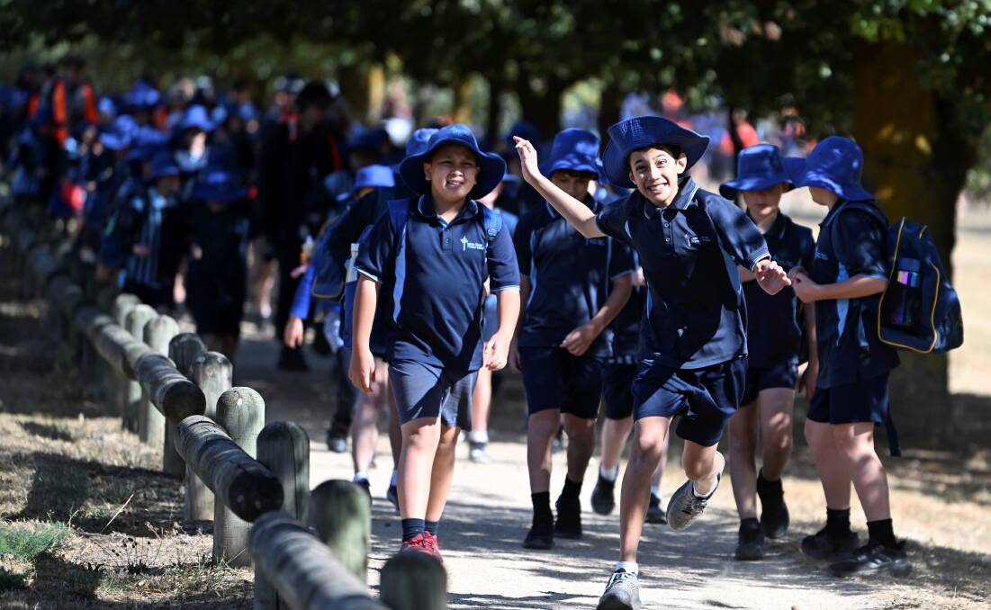 Lumen Christi pupils make their way through Victoria Park for their annual charity walkathon. Picture by Lachlan Bence