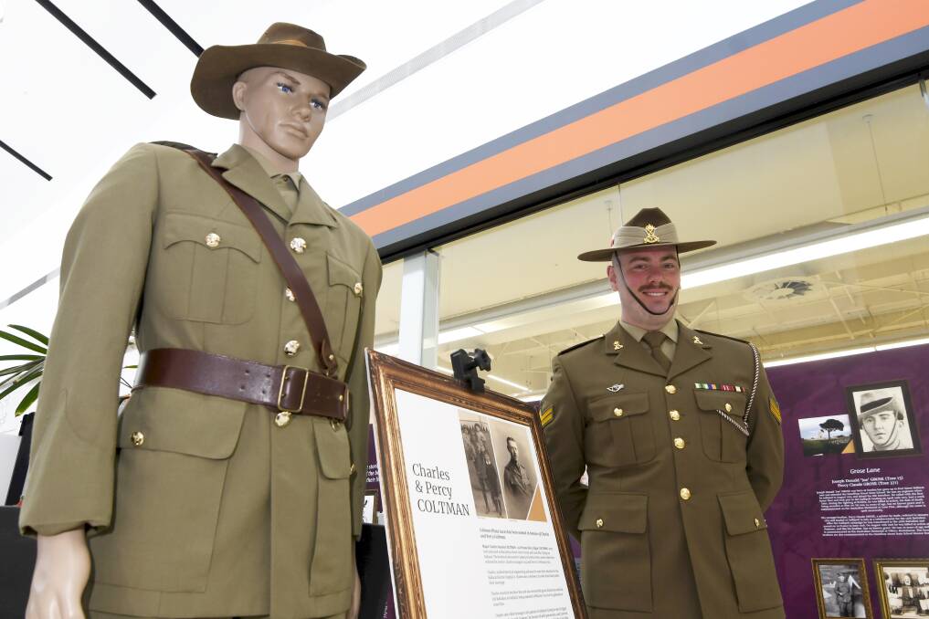 HISTORY: Cpl George Coltman at the opening of Honoured in Lucas alongside a display about his great great great uncles, World War I veterans Charles and Percy Coltman. Pictures: Lachlan Bence