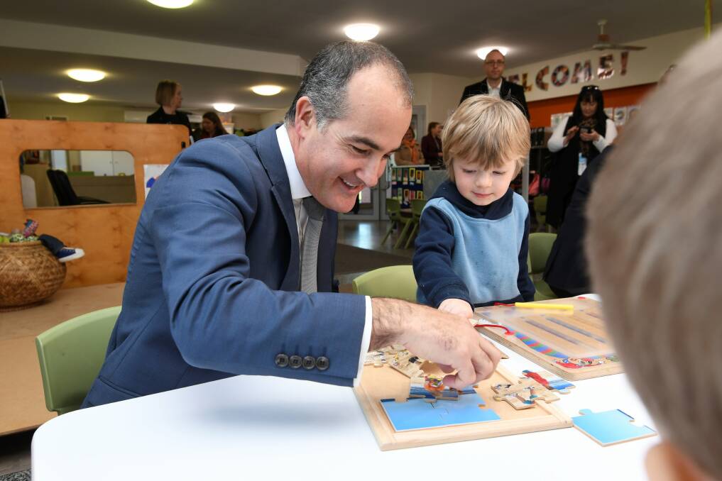 PLAYTIME: Education minister James Merlino and Fredrick at the Wendouree Children's Centre. Picture: Lachlan Bence
